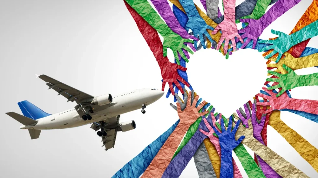 A imagem mostra uma arte gráfica contendo um avião voando em direção a um coração feito com mãos de papel coloridas, representando a diversidade e a inclusão na indústria aeronáutica